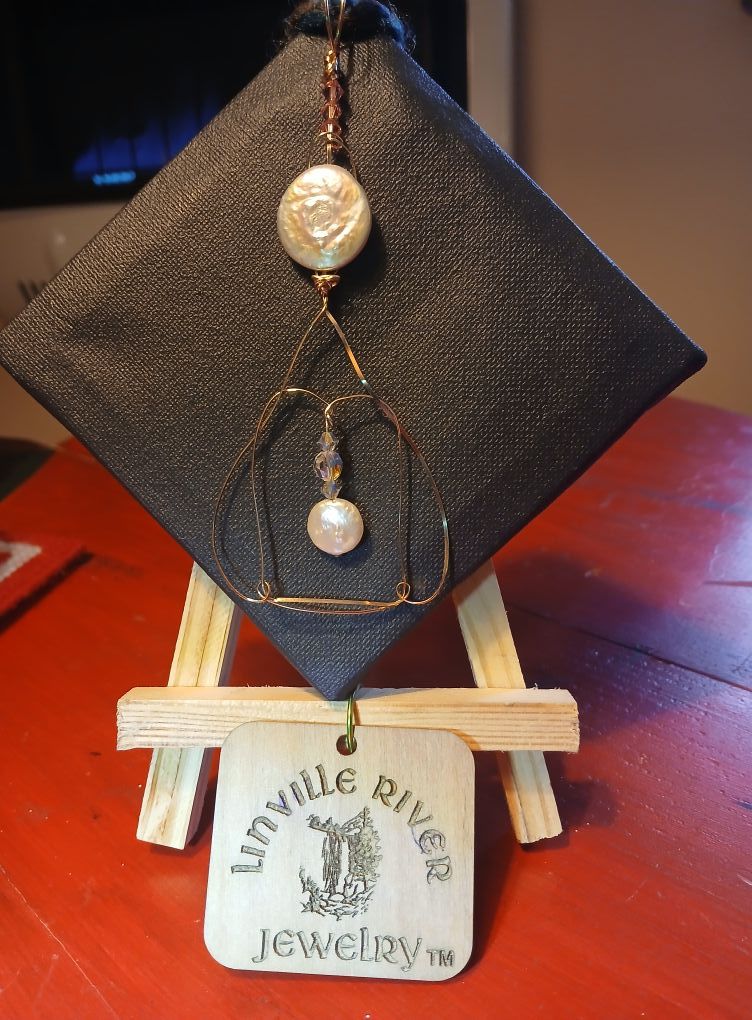 A necklace with a tag that says linville river jewelry