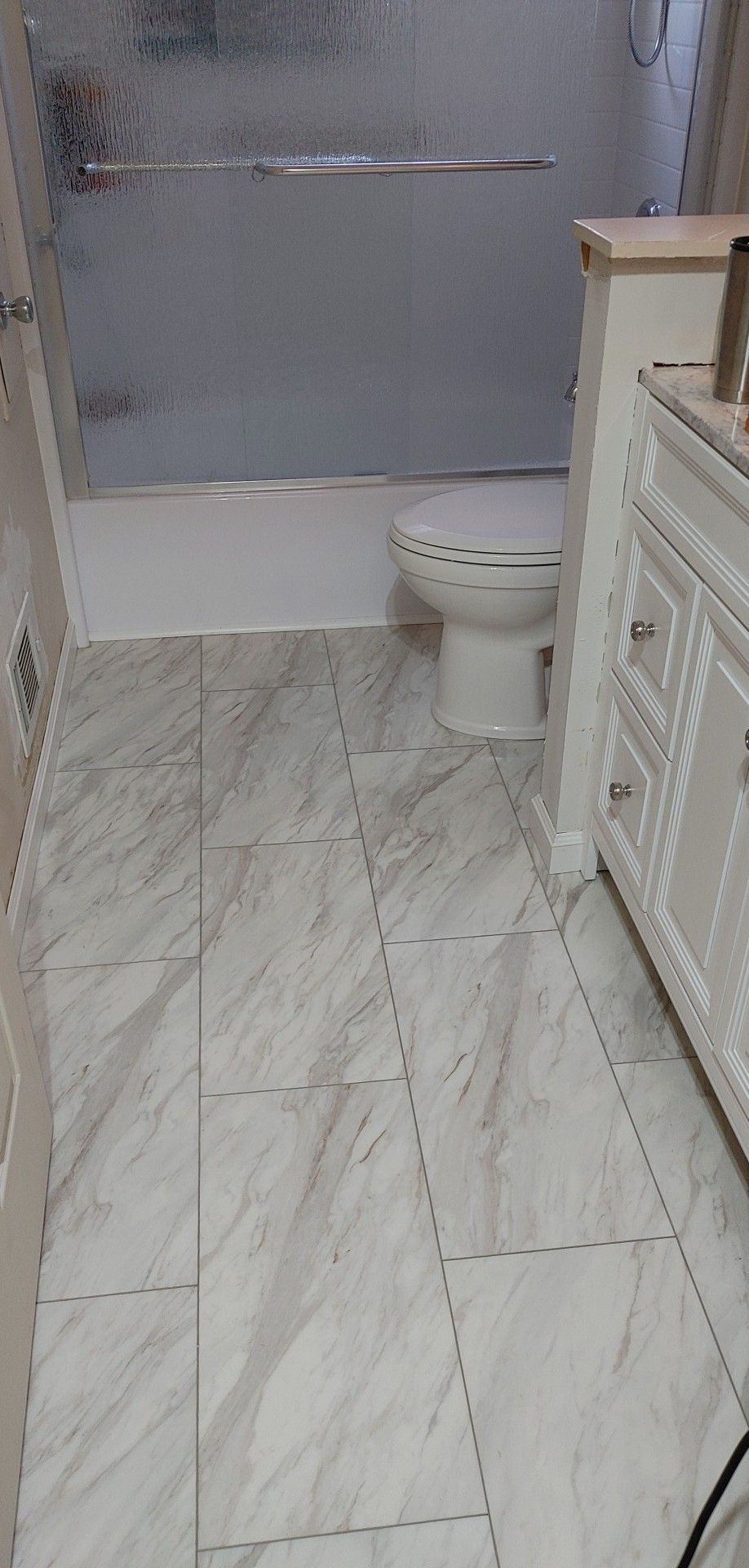 A bathroom with a toilet , sink , and shower.