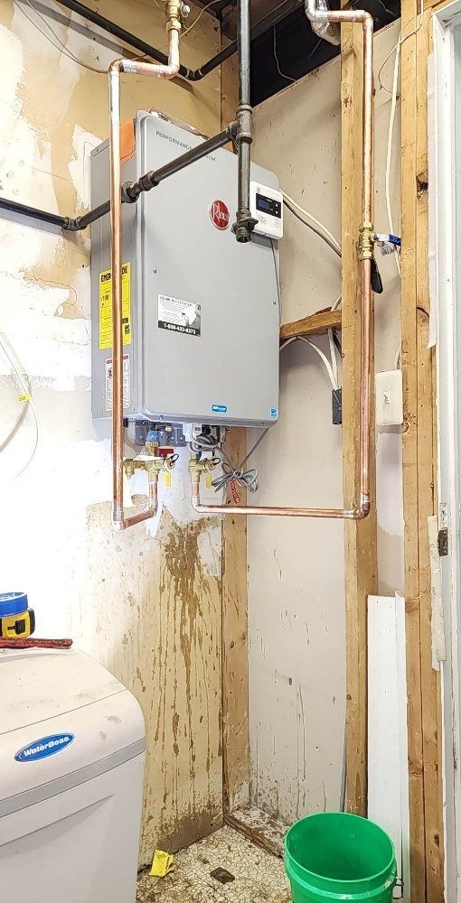 A laundry room with a washer and dryer and a green bucket.