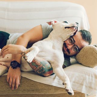 Man holding his dog on a couch | Country Ridge Apartments