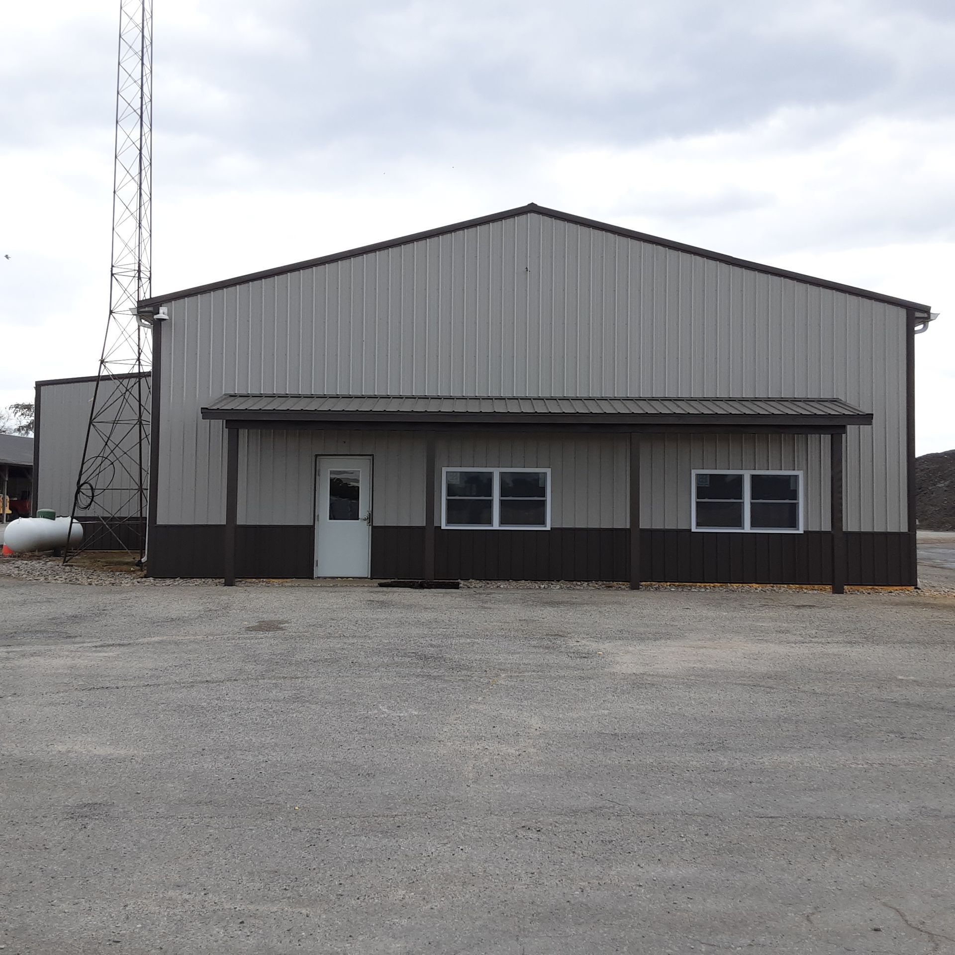 A large gray building with a white door and windows