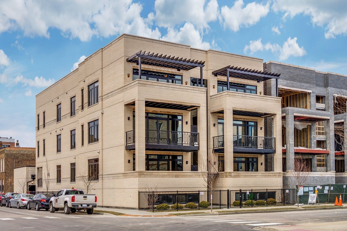 a white truck is parked in front of a building that is under construction