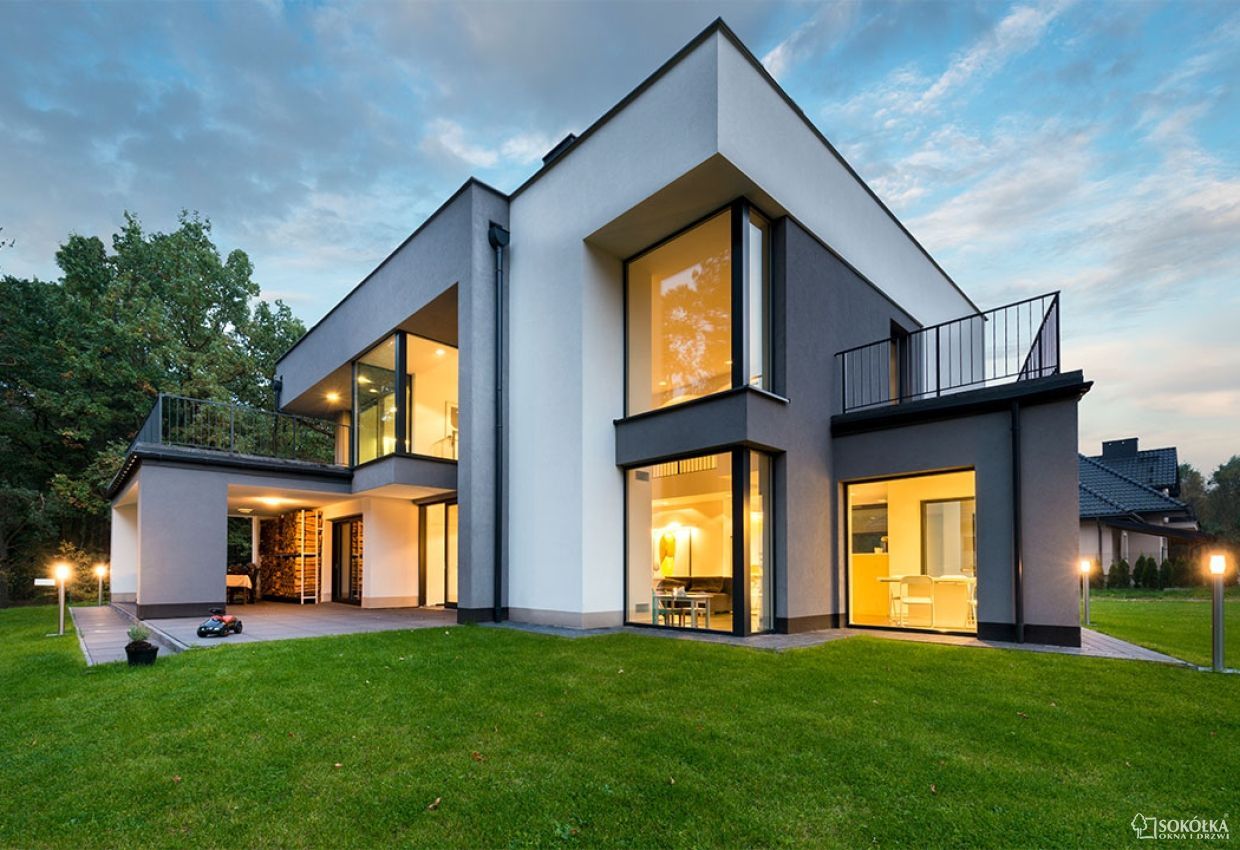 a modern house with a lawn mower in front of it