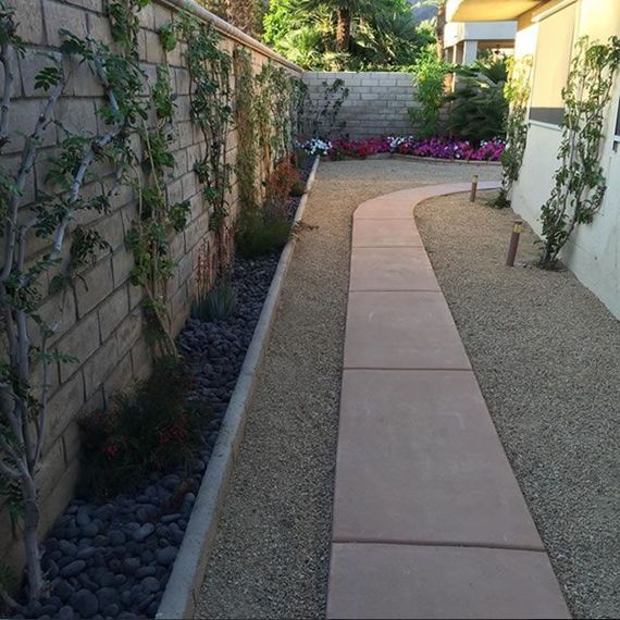 A walkway with a brick wall in the background