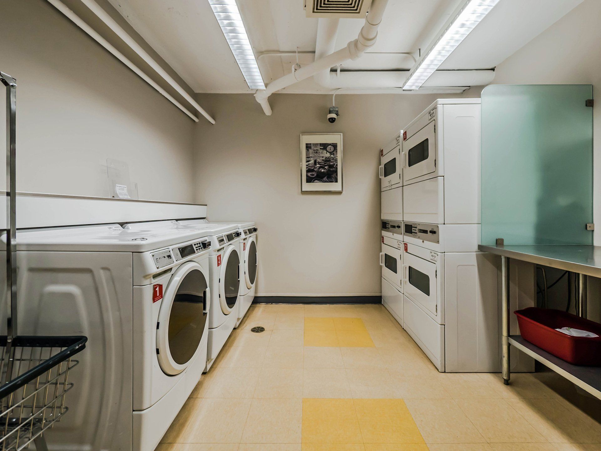 A laundry room with a lot of washers and dryers at Reside on Morse.