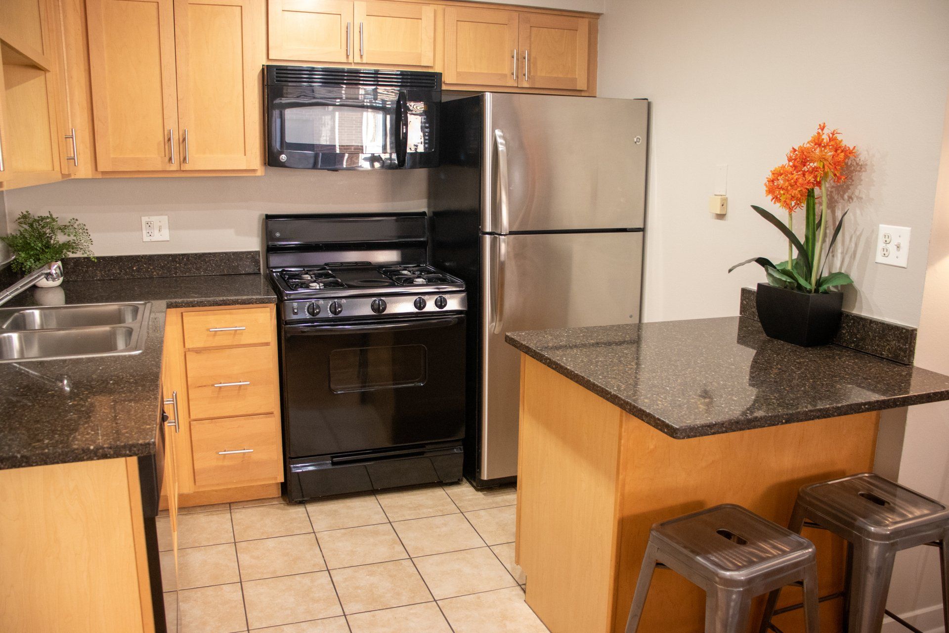 A kitchen with stainless steel appliances and granite counter tops at Reside on Morse.