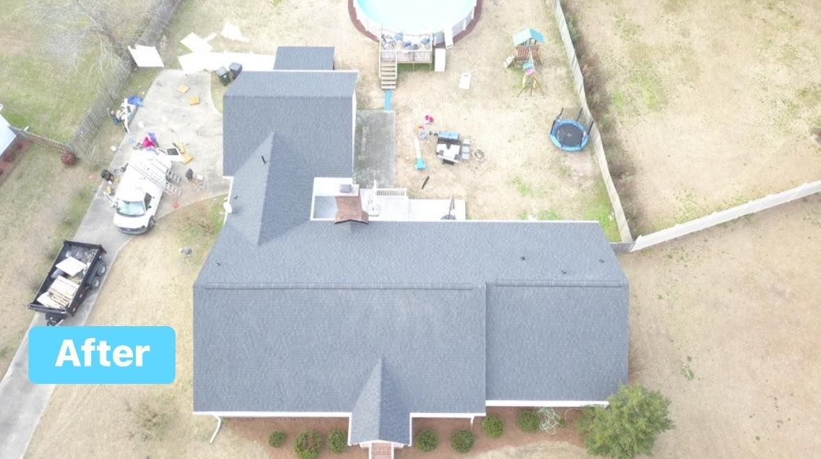 Aerial view of a house with a newly shingled gray roof.