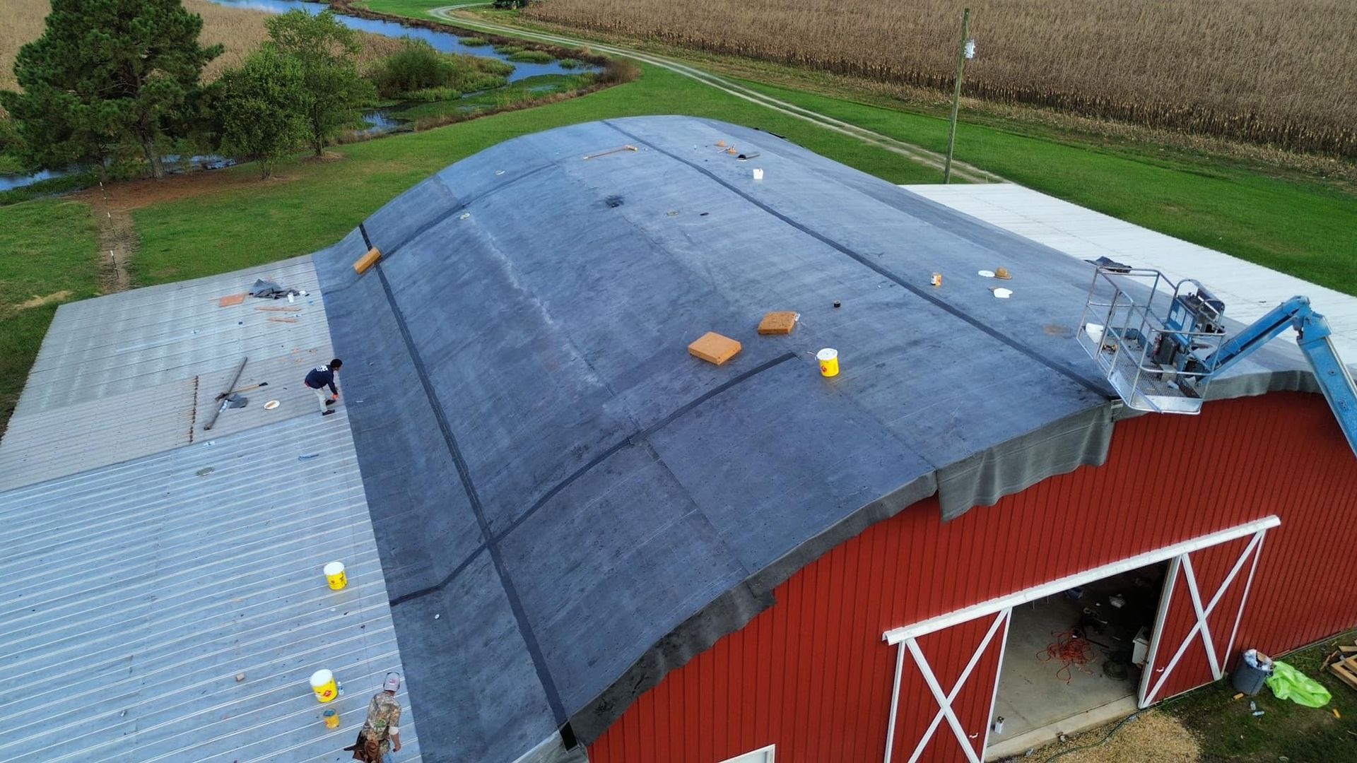 An aerial view of a brick building with a brown roof