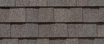 Close-up of overlapping gray asphalt roof shingles.
