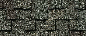 Close-up of overlapping dark gray asphalt roof shingles.