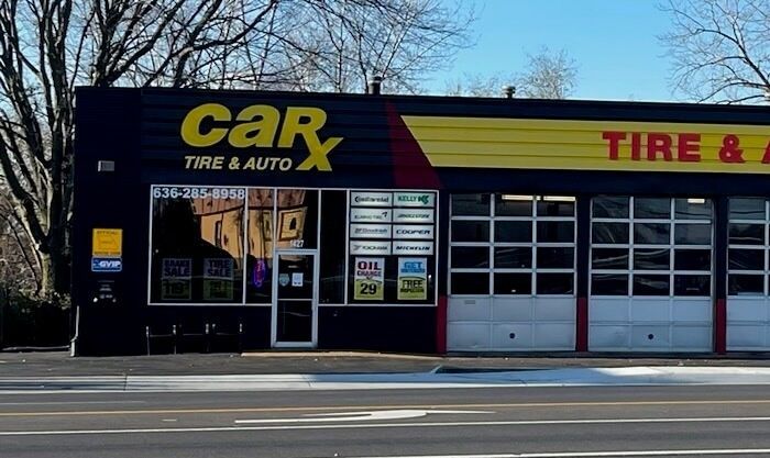 CarX Tire & Auto shop storefront with black facade and yellow and red accents.
