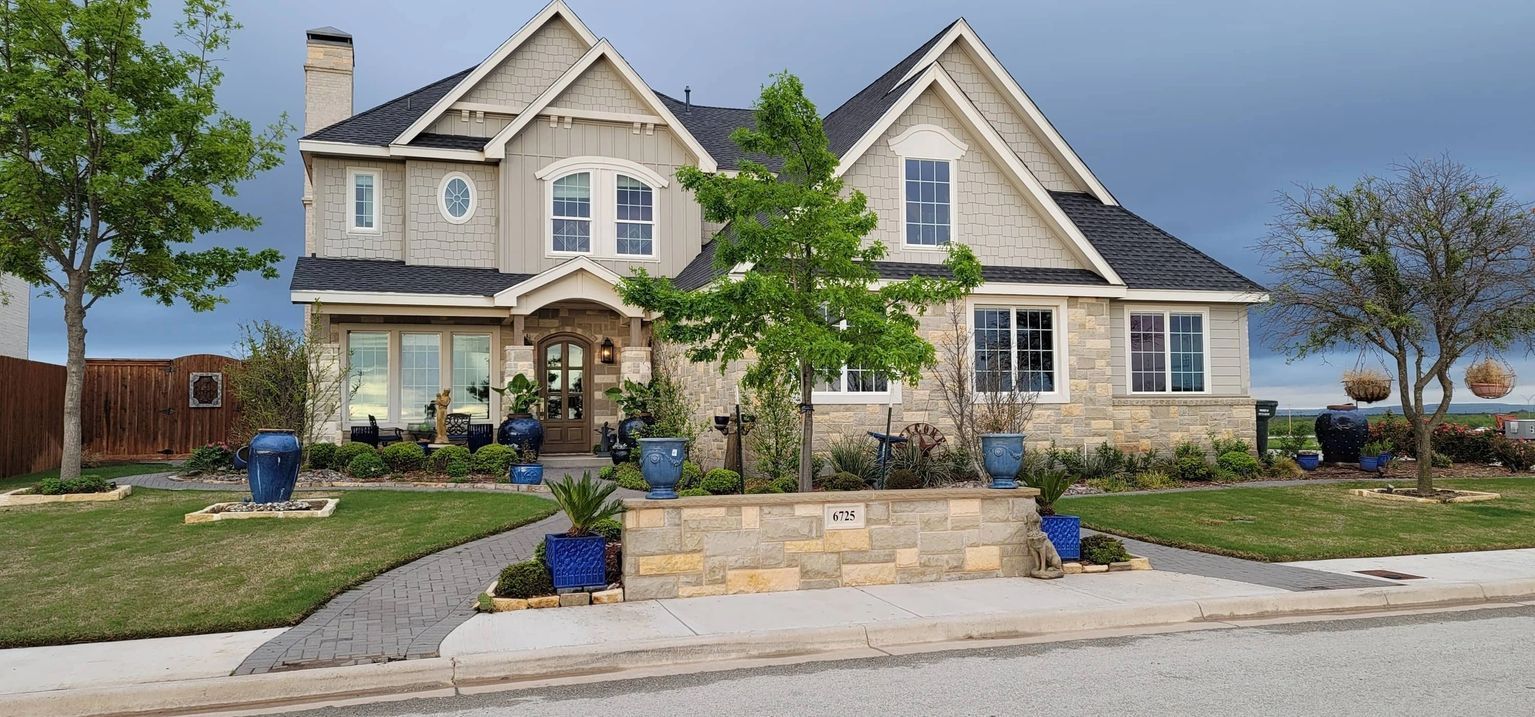 A large house with a lot of windows and trees in front of it.