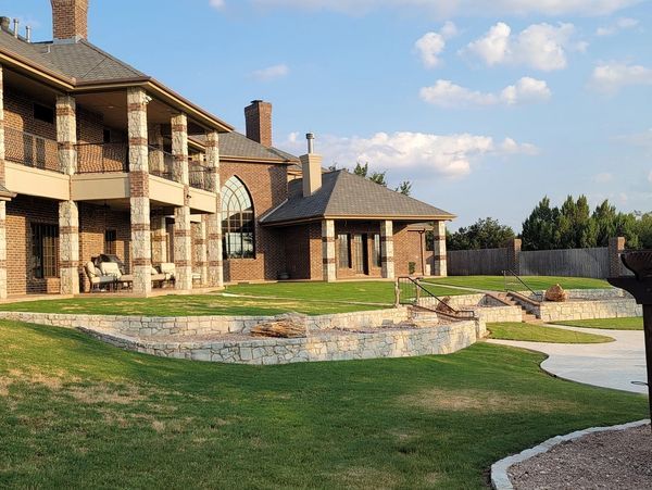 A large house with a large lawn in front of it