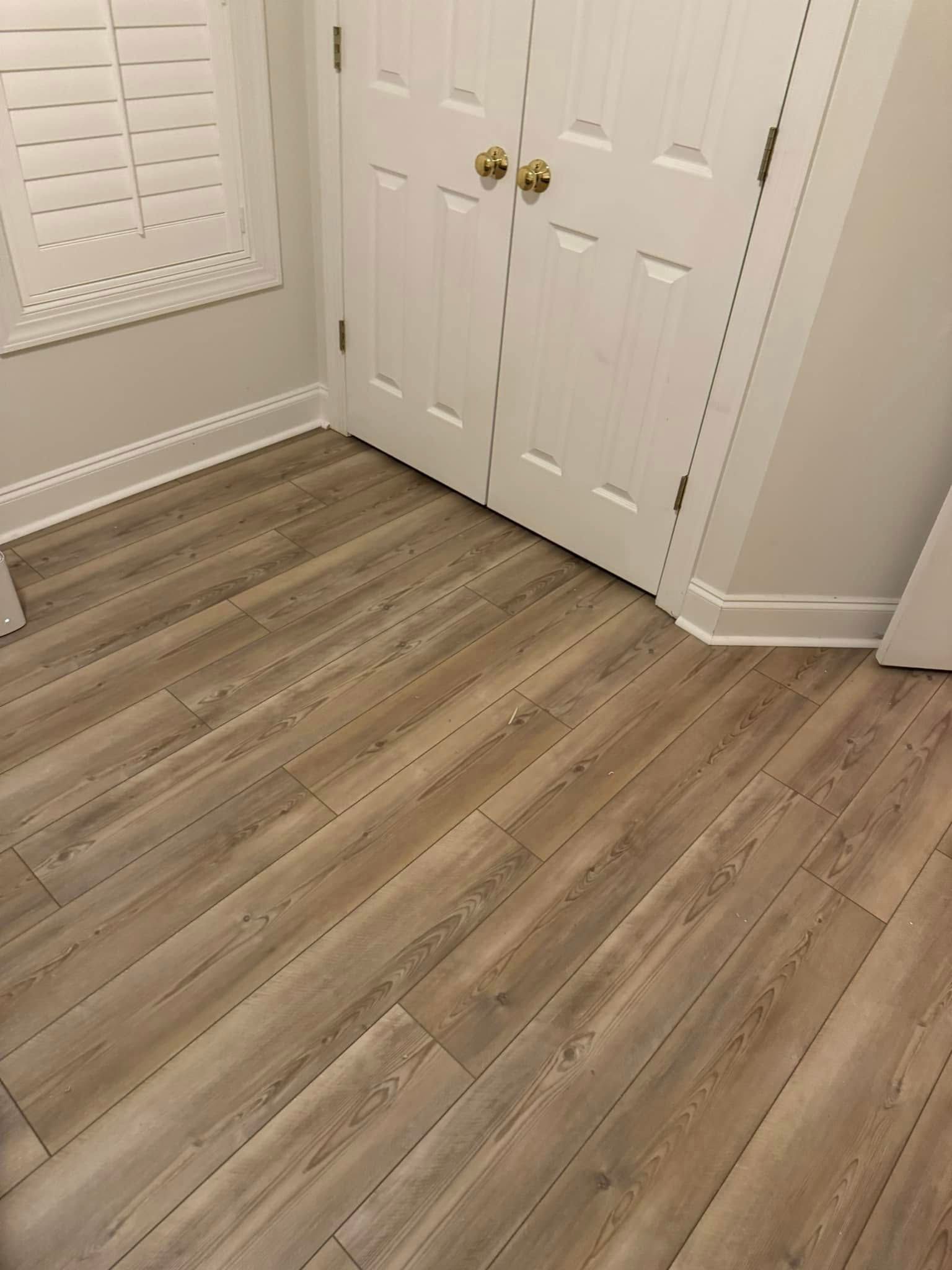 A wooden floor in a closet.