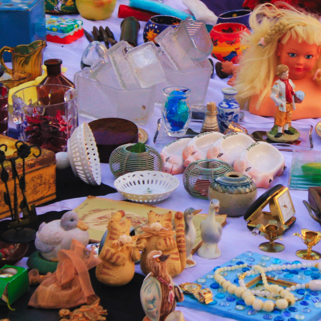 A table full of various items including a doll head.