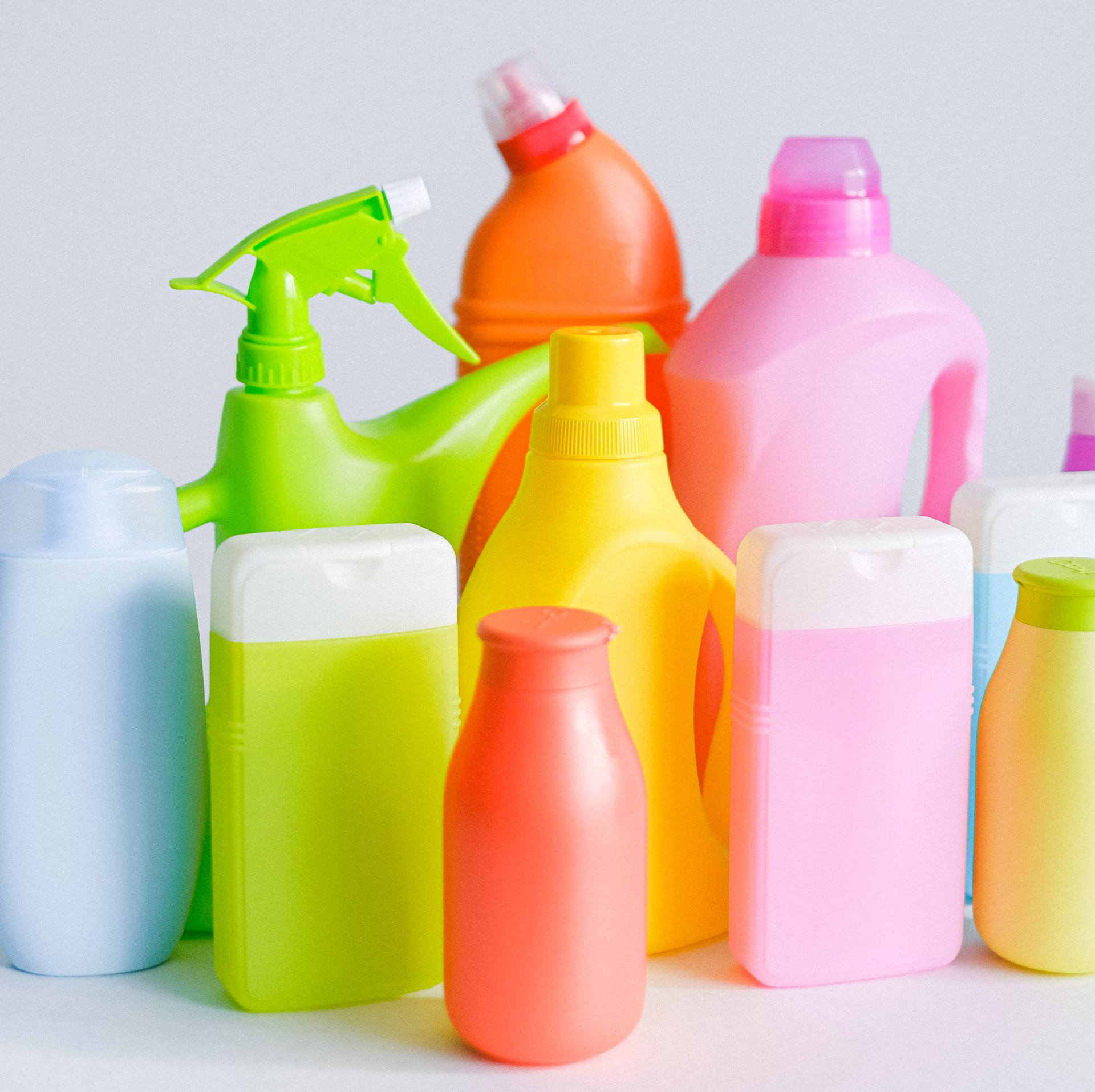A bunch of different colored bottles of cleaning products