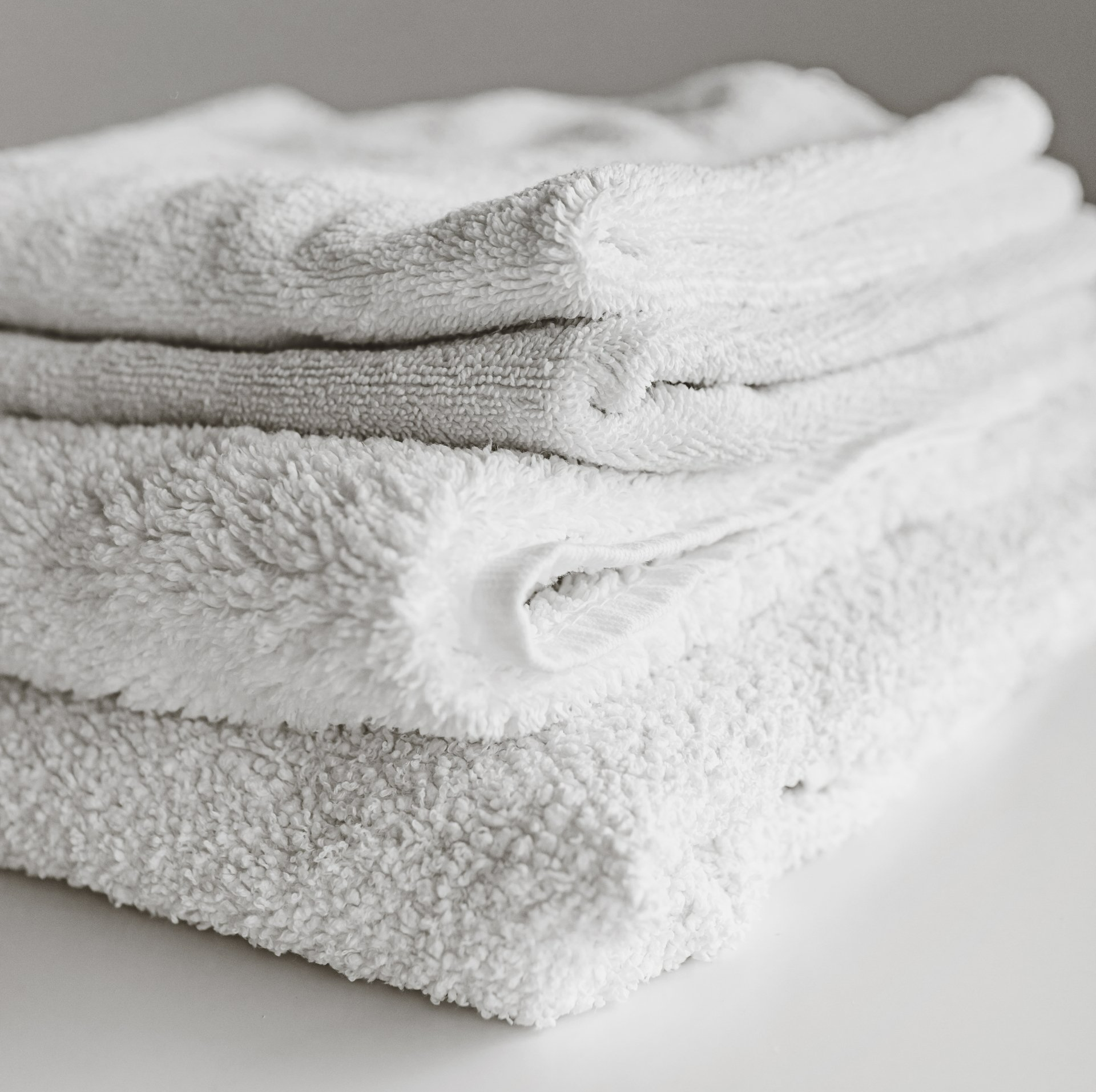 A stack of white towels sitting on top of each other.