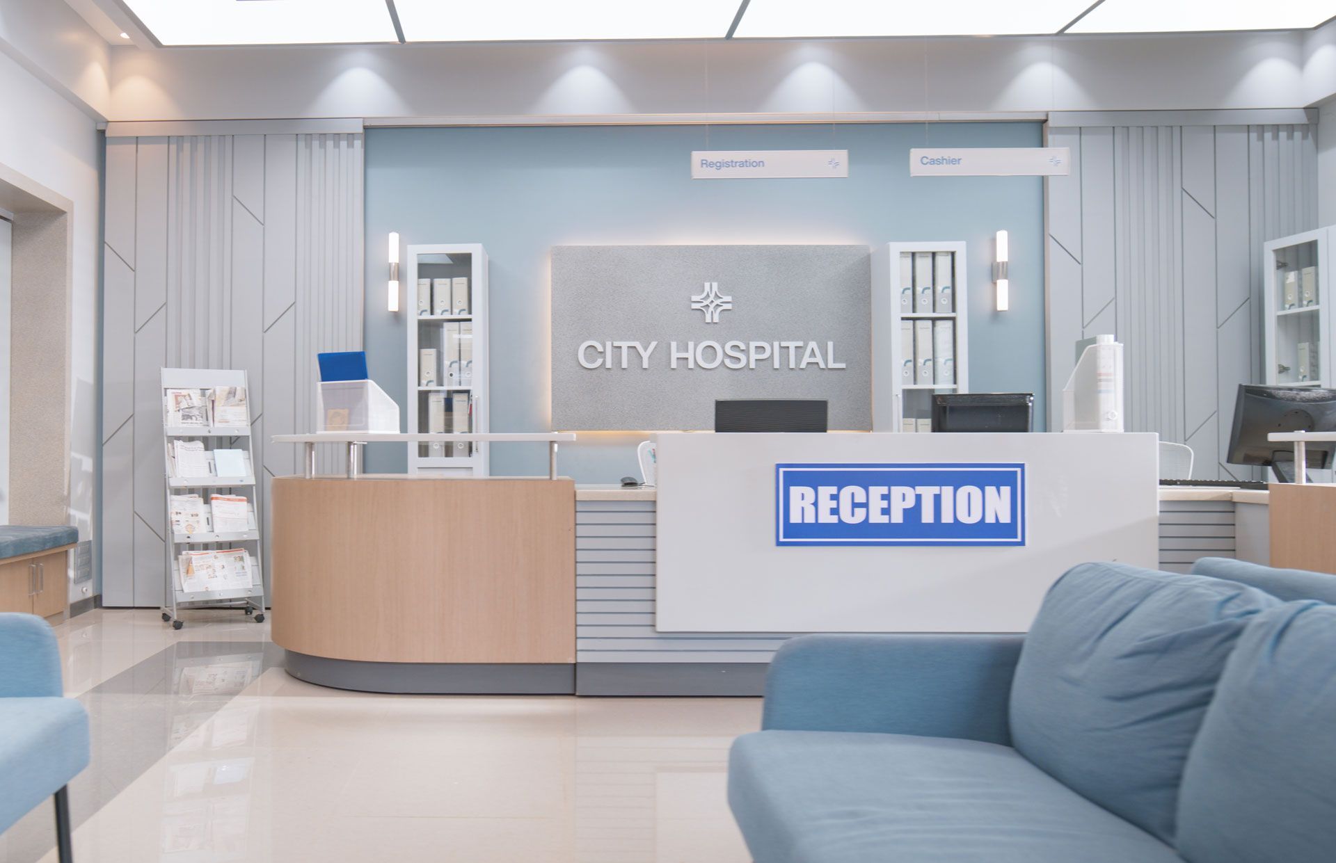 Hospital reception area with a blue-gray color scheme, including a reception desk and seating.