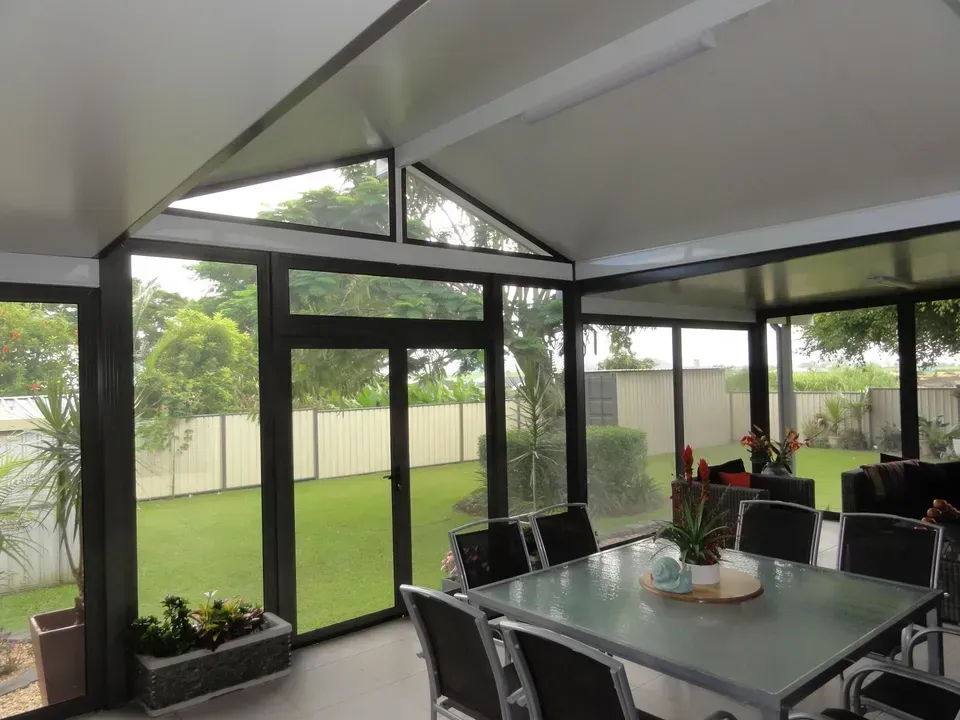 Enclosed Patio With Glass Walls, Outdoor Dining Set — Big Tom's Security Screens in Farleigh, QLD