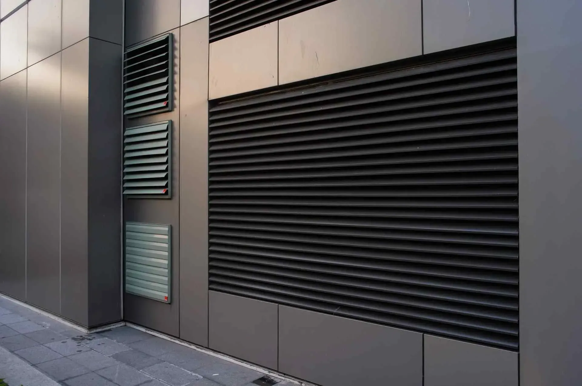 Gray Building Exterior With Ventilation Grilles — Big Tom's Security Screens in Farleigh, QLD