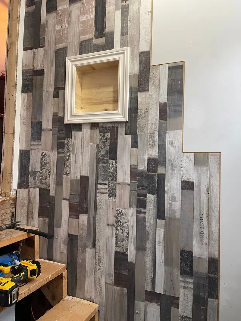 Un mur en bois avec un cadre photo dessus.