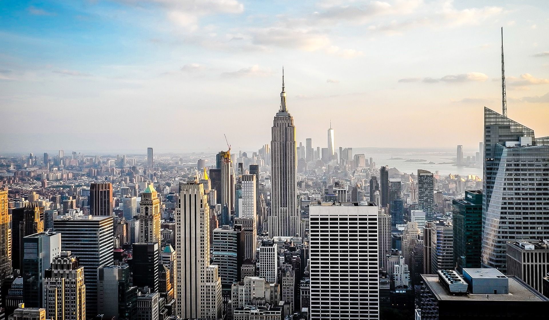 An aerial view of a city skyline with the empire state building in the foreground
