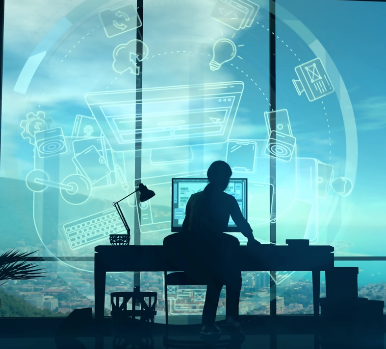 A man is sitting at a desk in front of a computer.