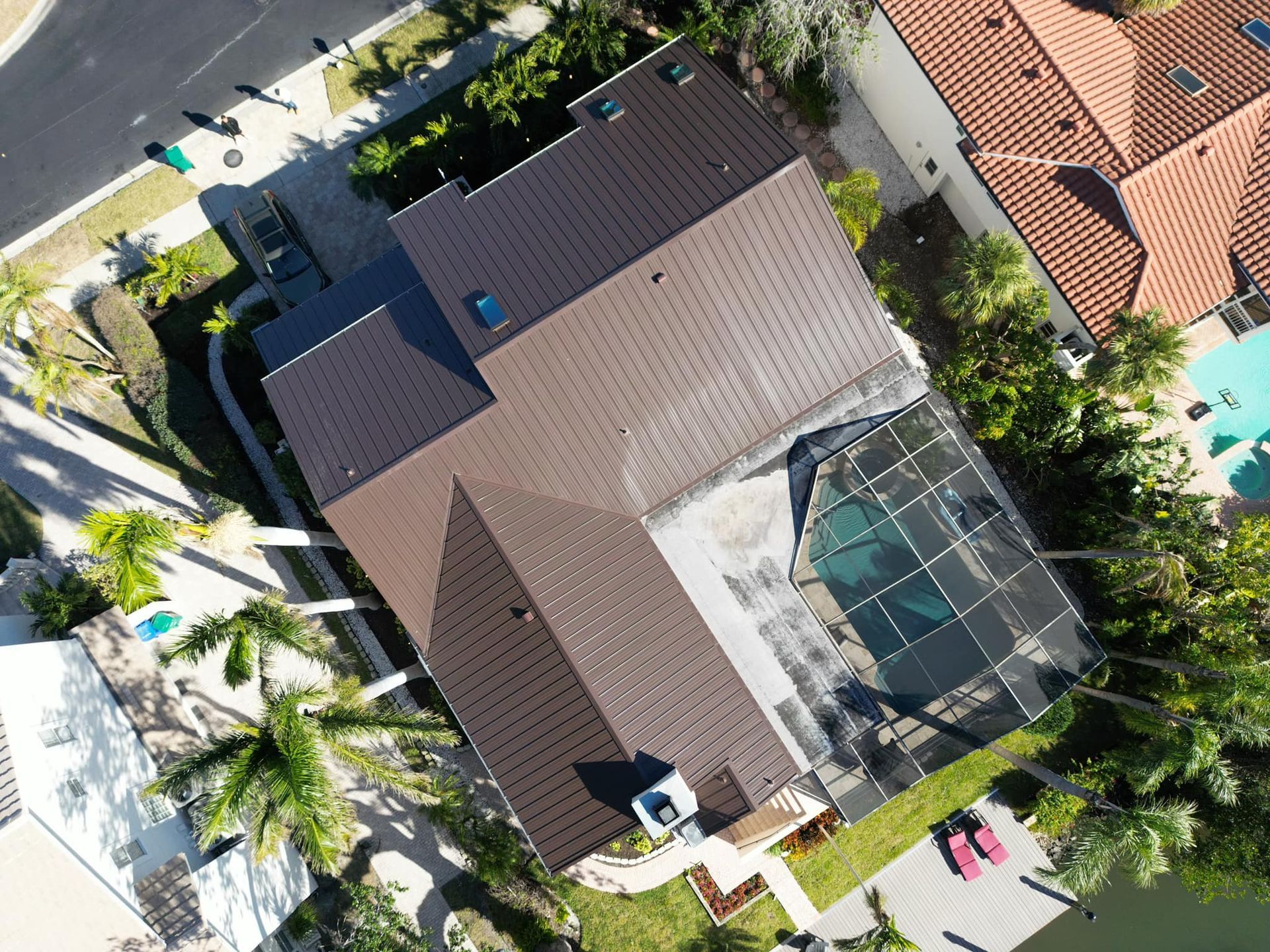 An aerial view of a house with a brown roof