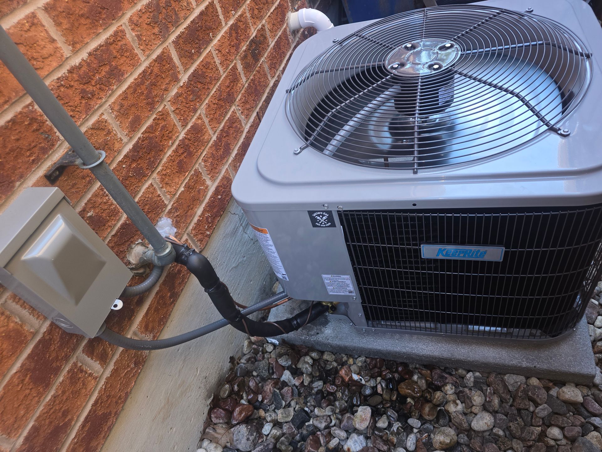 Air conditioning unit outside a brick building.