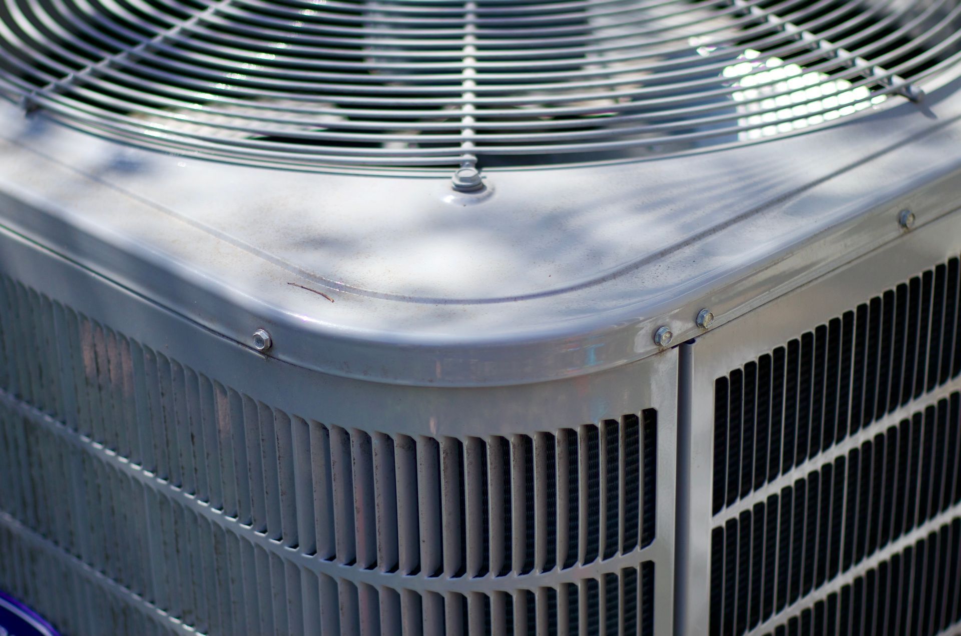 A close up of an air conditioner with a fan on top of it.