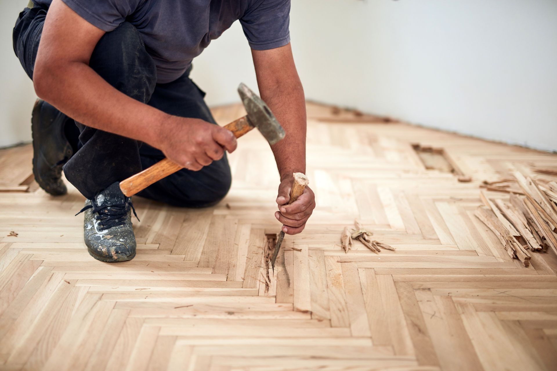 Repairman restoring old parquet hardwood floor.