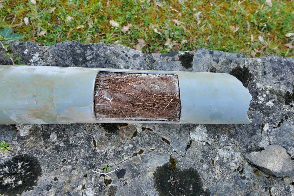 A Metal Pipe With A Hole In It Is Sitting On A Rock — Tweed Heads Leak Detection in Casuarina, NSW