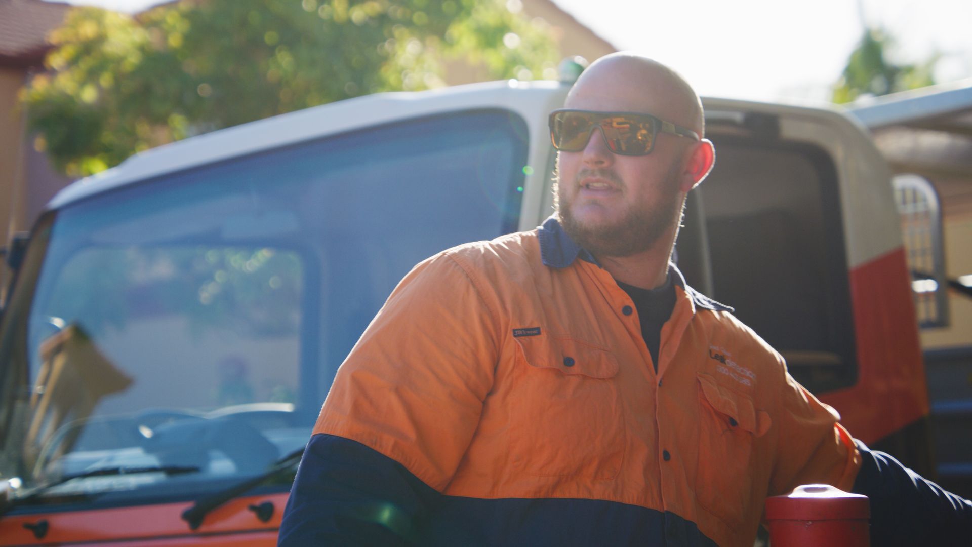 A Man Wearing A Hard Hat And Gloves Is Working On Pipes — Tweed Heads Leak Detection in Casuarina, NSW