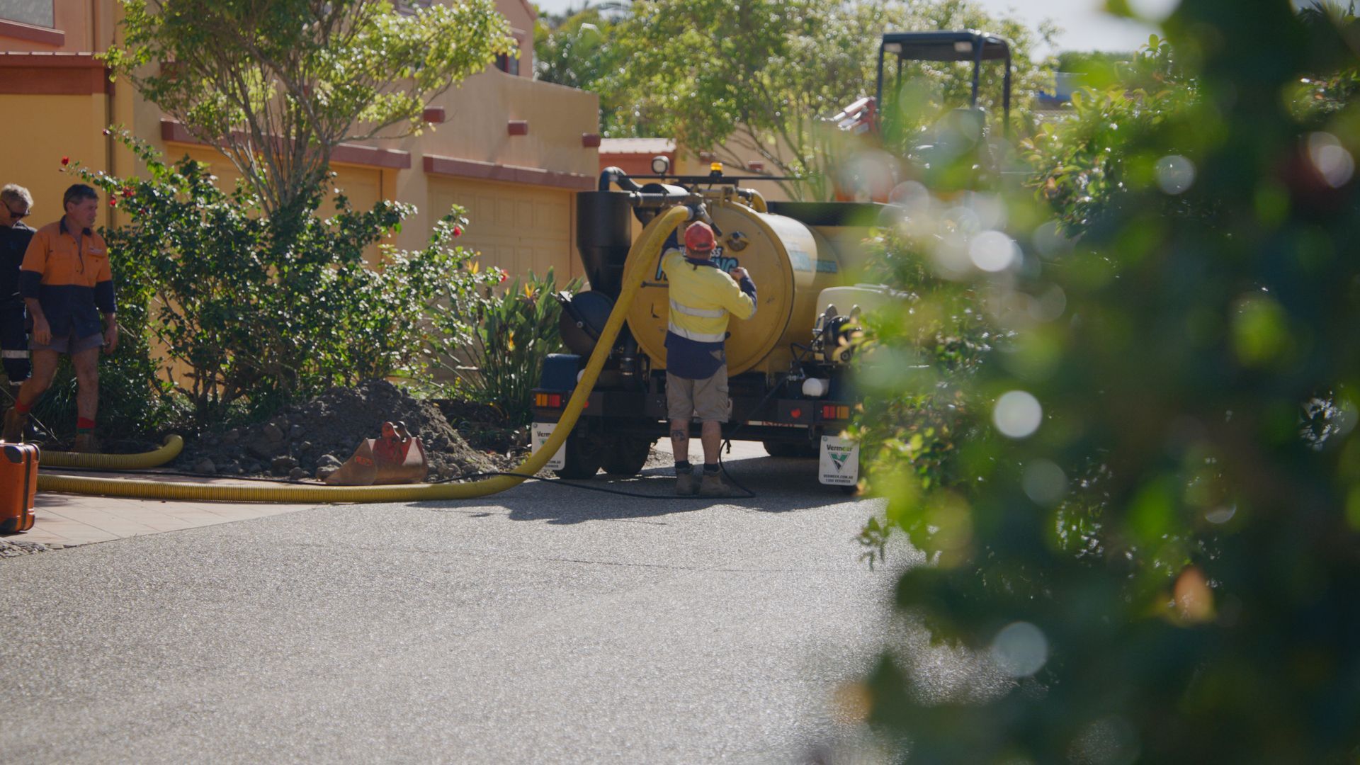 A Couple Of People Are Working On A Pipe In The Dirt — Tweed Heads Leak Detection in Casuarina, NSW