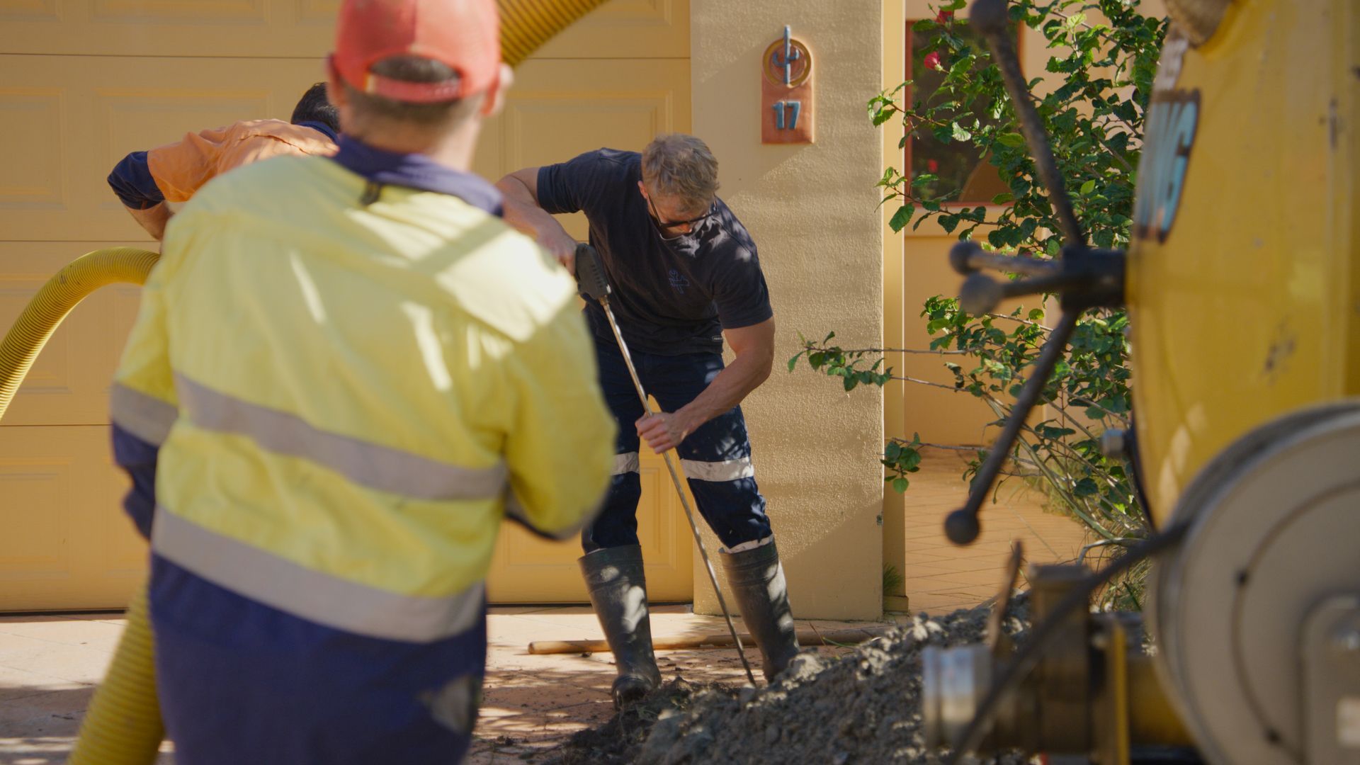 A Person Wearing Blue Rain Boots Is Standing In A Puddle — Tweed Heads Leak Detection in Casuarina, NSW