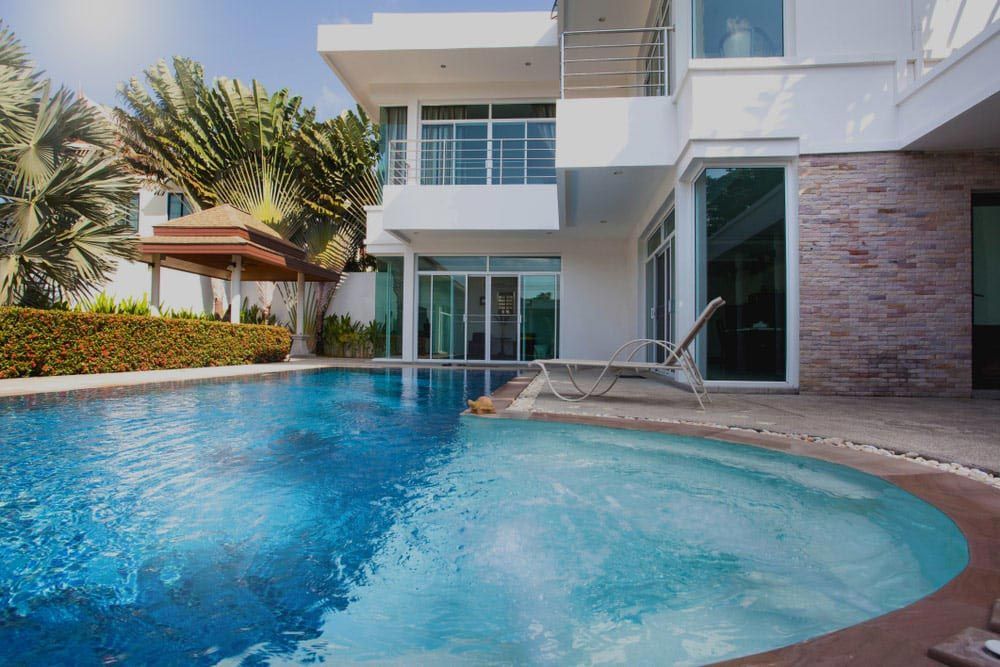 A Large House With A Swimming Pool In Front Of It — Tweed Heads Leak Detection in Casuarina, NSW