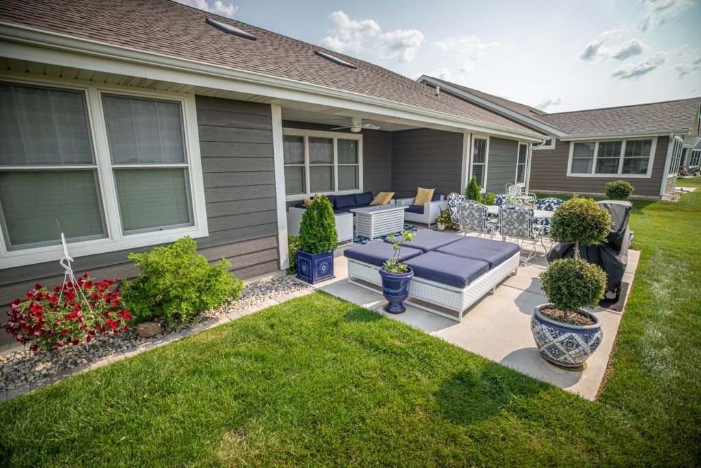 There is a patio area in front of a house.