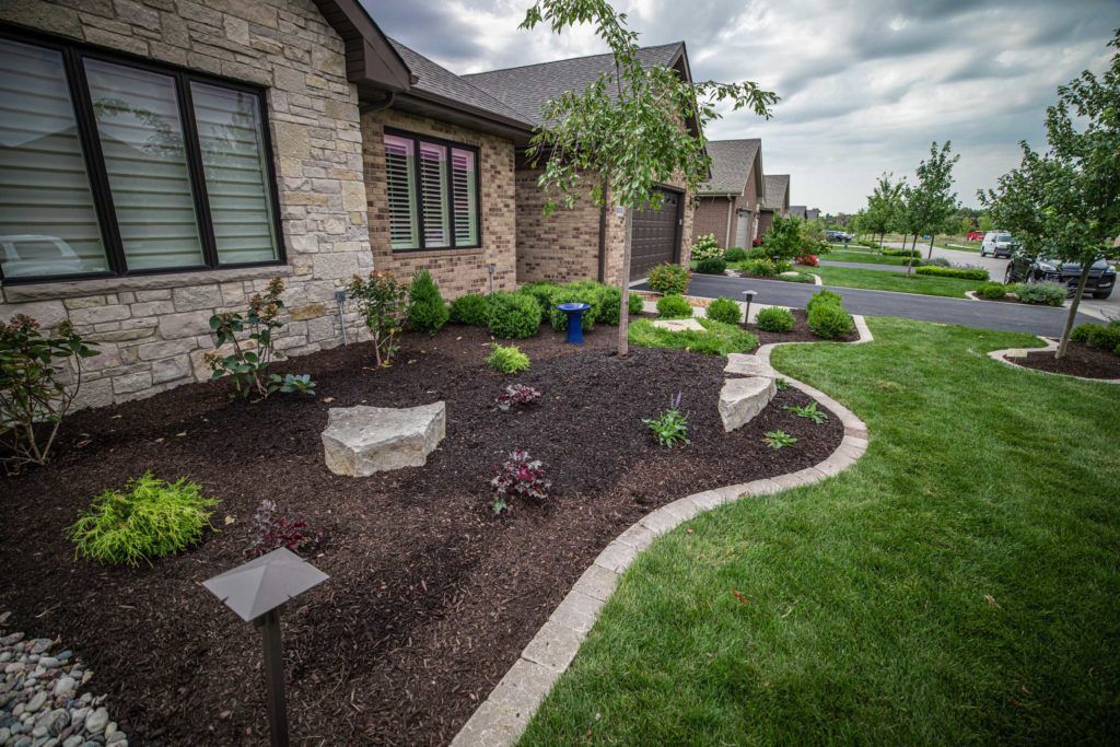 Luxury fire pit design surrounded by seating in a backyard retreat