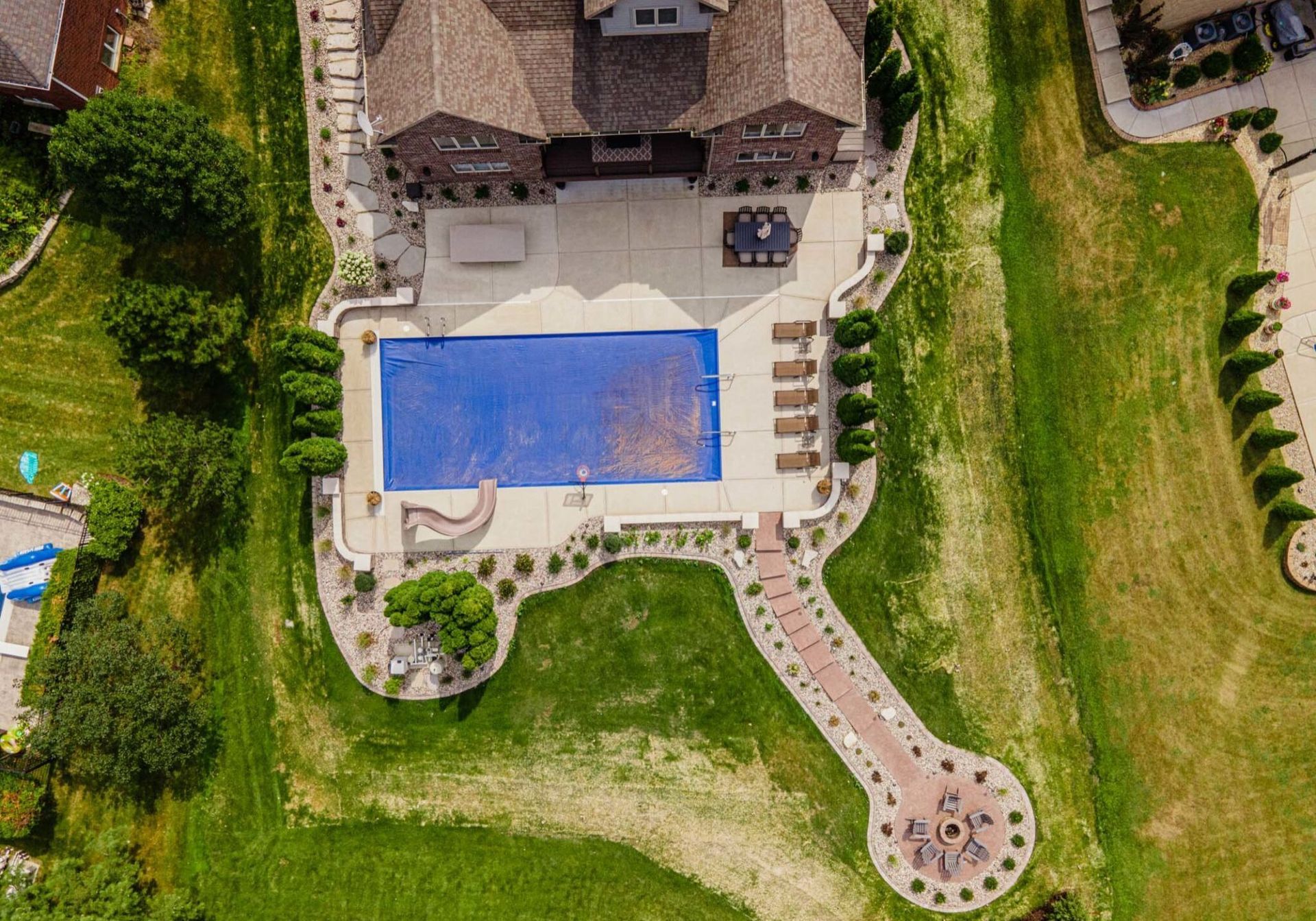 An aerial view of a large swimming pool in a residential area.