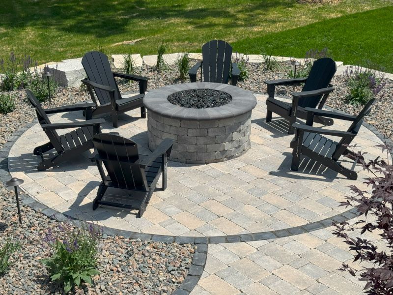 Luxury fire pit design surrounded by seating in a backyard retreat