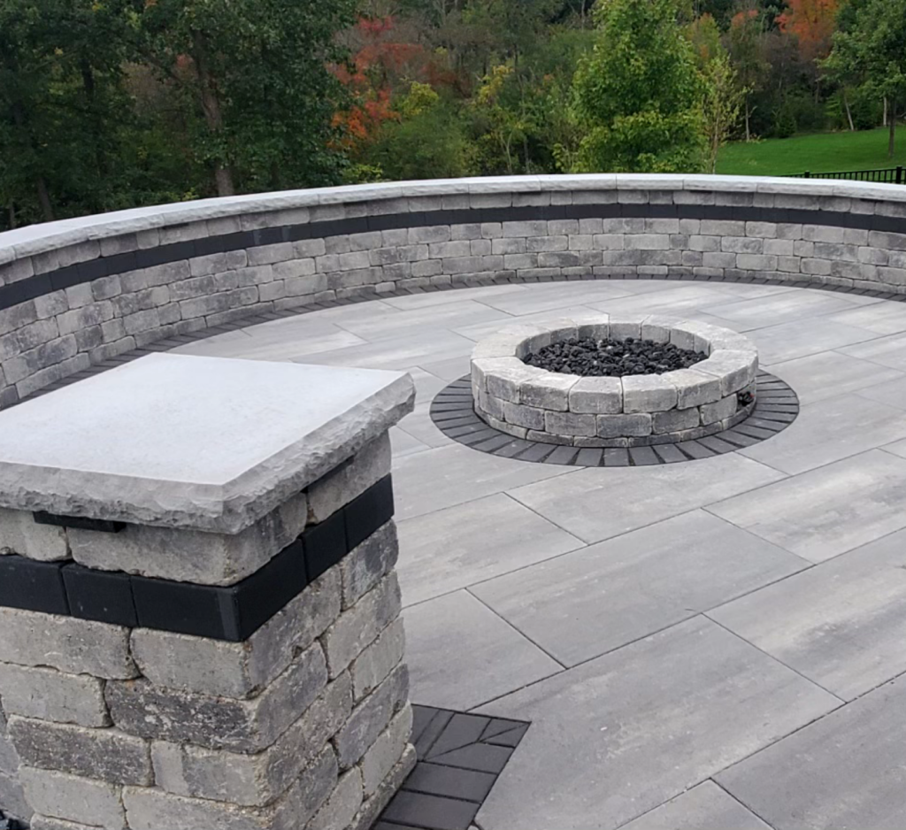 A patio with a fire pit in the middle of it