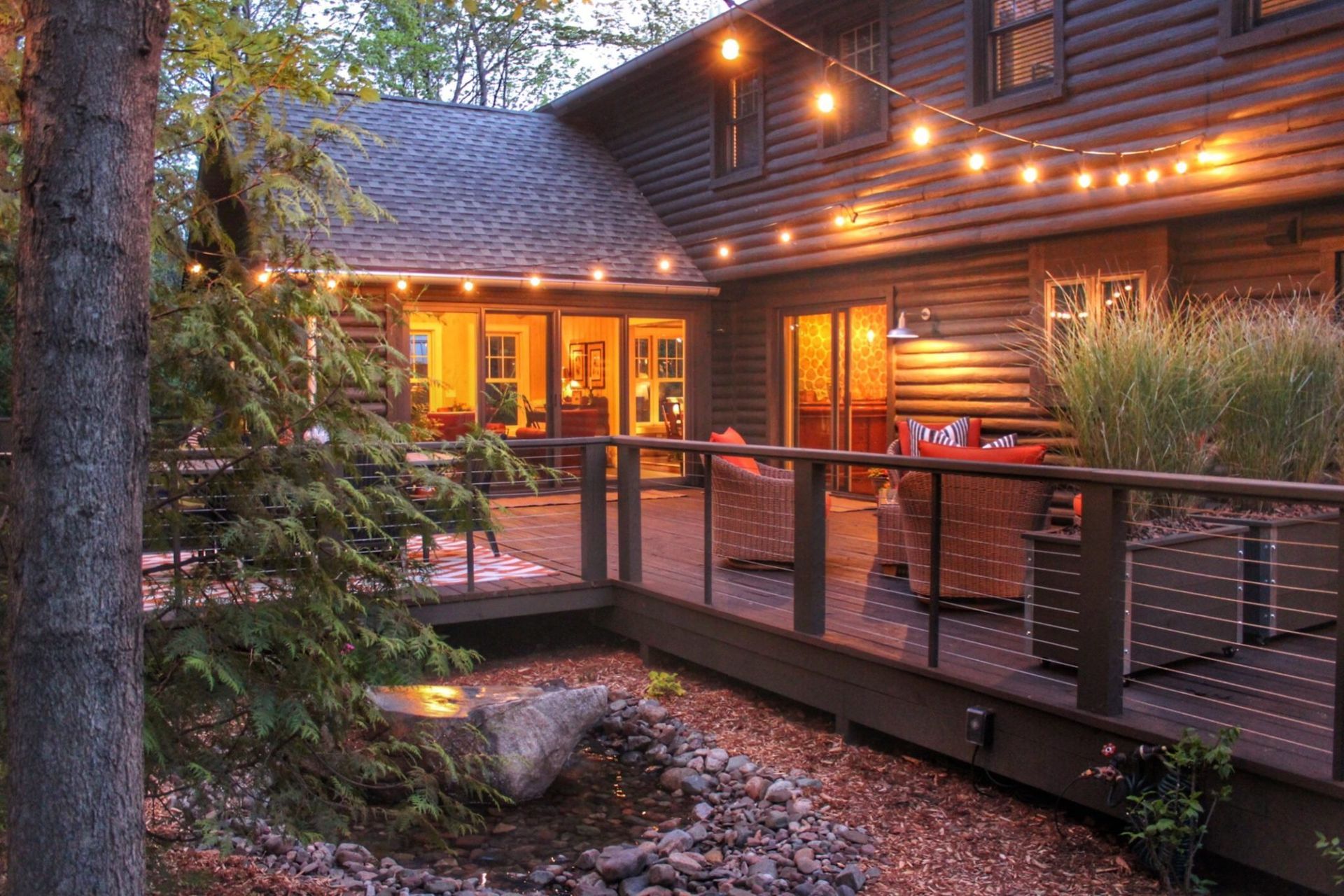 A house with a deck and a bridge leading to it