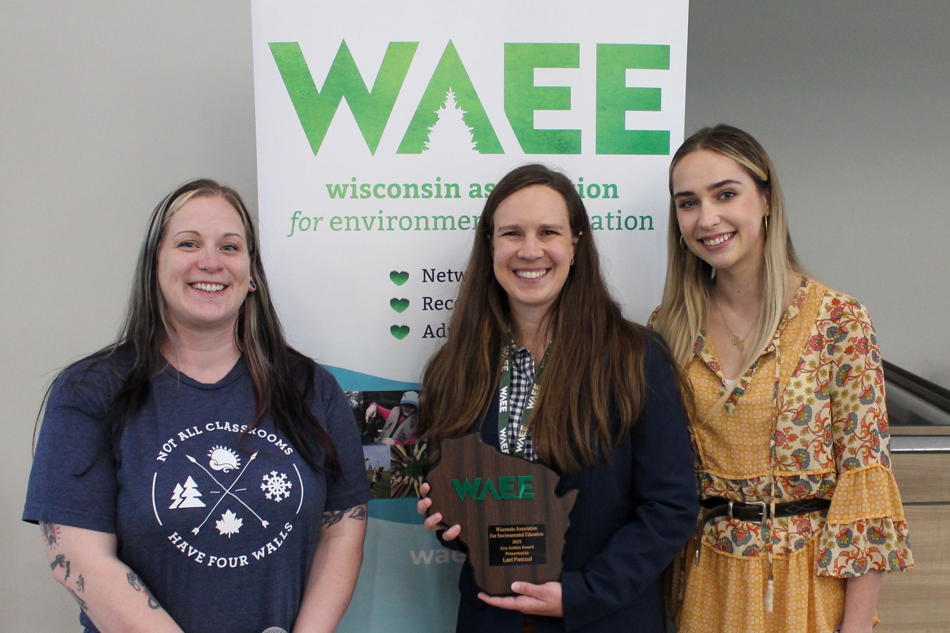 Beca Borkowski and Xia Lowery stands with award winner Lael Pascal