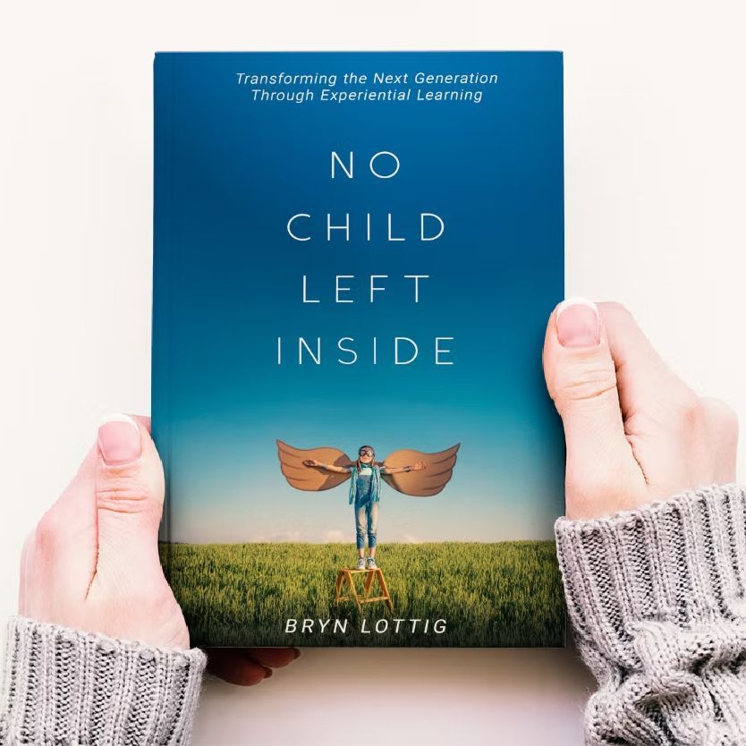 Hands holding a book titled 