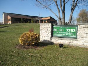 Nature center on a hill with a sign