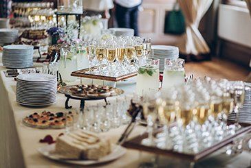 Event Catering — Stylish Champagne Glasses and Food Appetizers on Table in Township, NJ