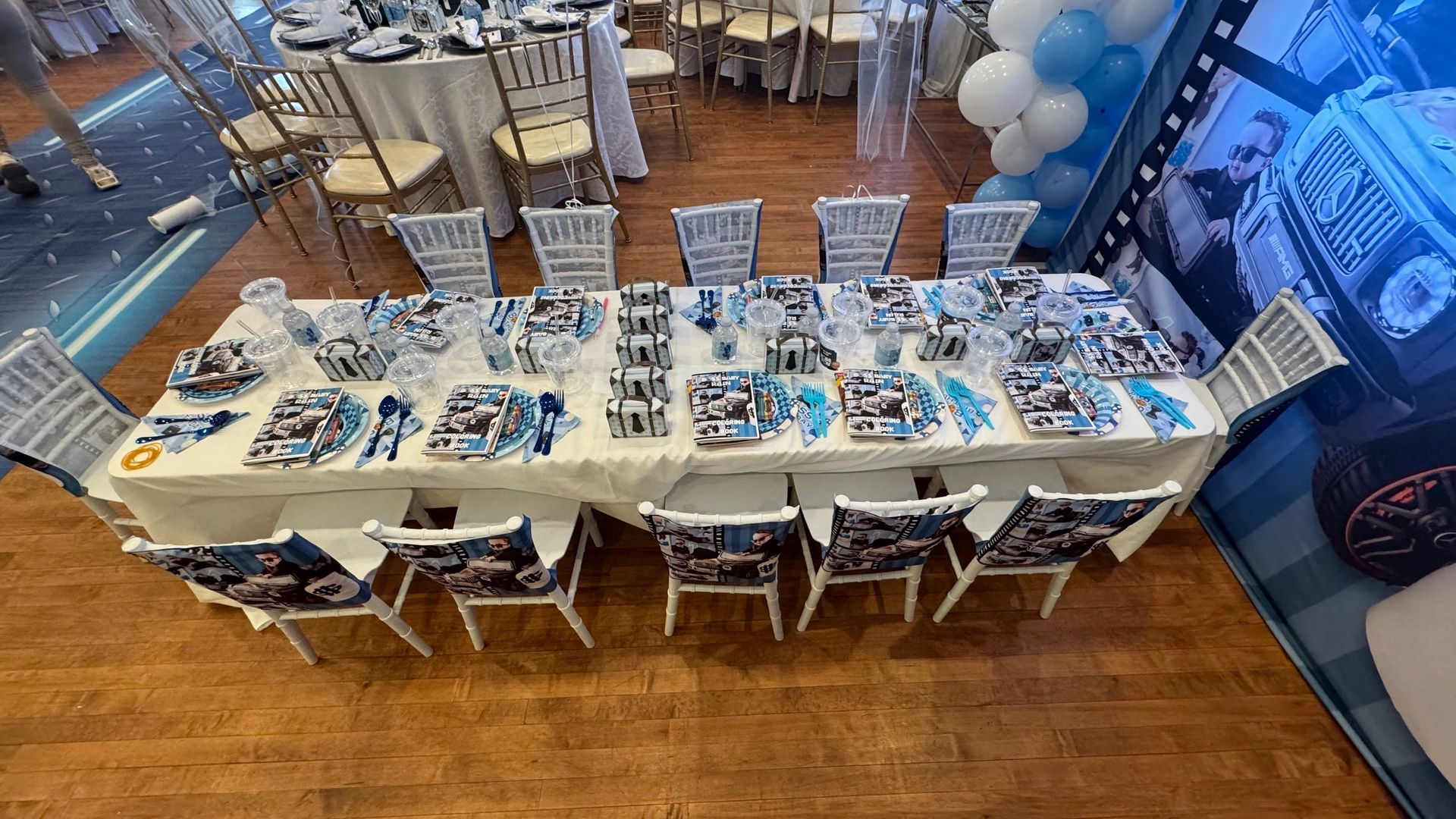 A long table with chairs and plates on it in a room.