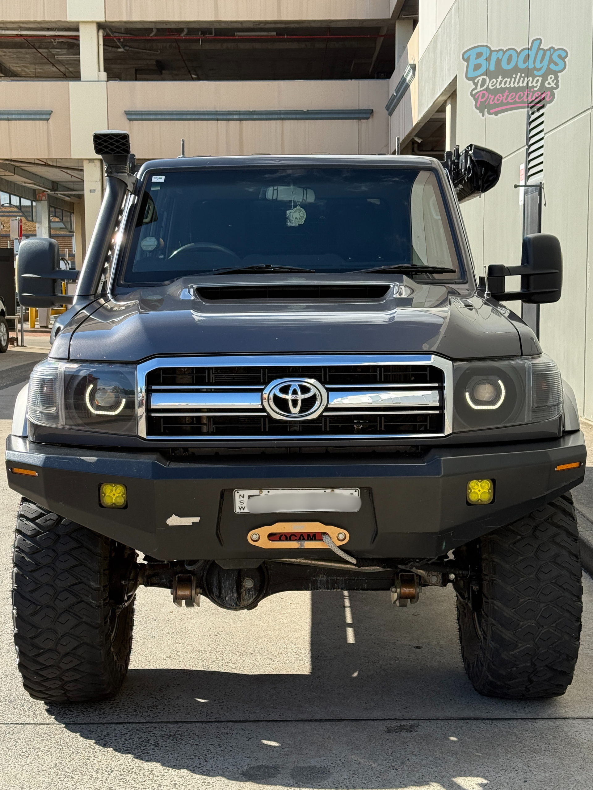 Dark grey Toyota Land Cruiser with off-road modifications, including a front winch and snorkel. — Brody’s Car Detailing In Tamworth, NSW