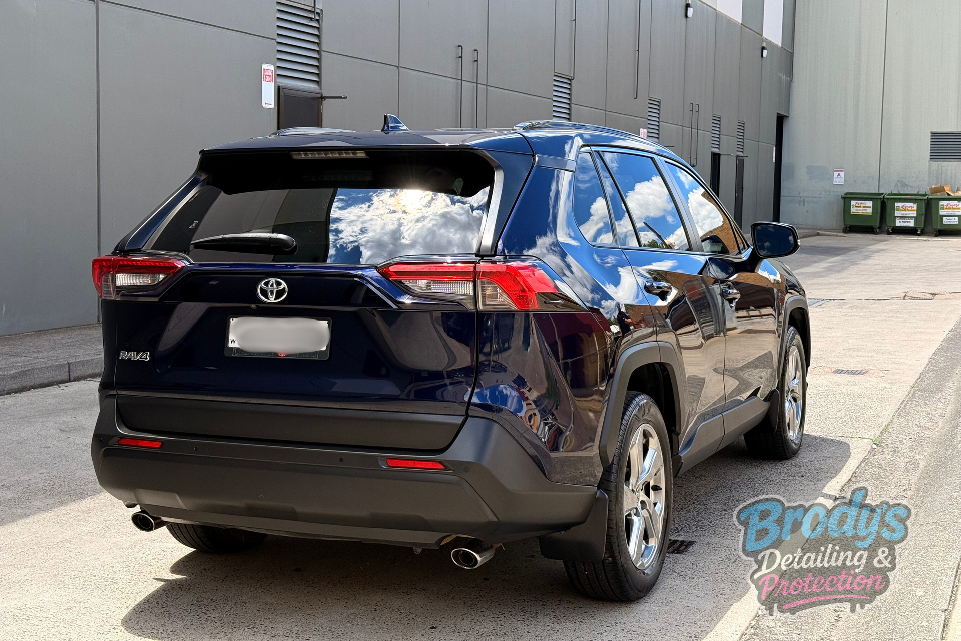Dark blue Toyota RAV4 parked on pavement next to a grey building. — Brody’s Car Detailing In Tamworth, NSW