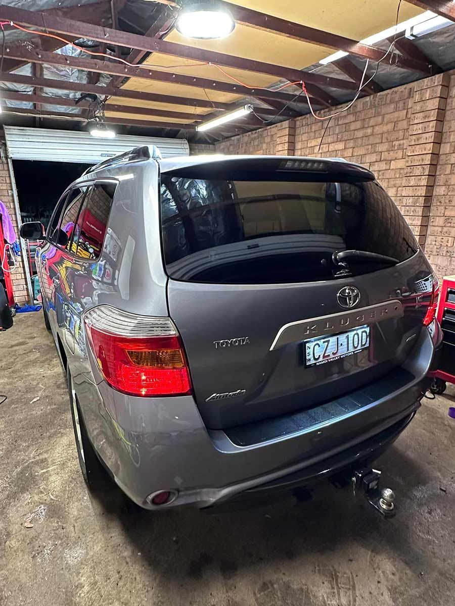 A Gray SUV Is Parked In A Garage Next To A Brick Wall — Brody’s Car Detailing In Oxley Vale, NSW